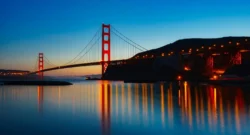 Golden Gate Bridge reflecting in the water during sunset in San Francisco. Iconic architectural landmark.