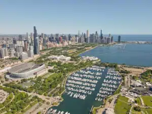 A stunning aerial shot of Chicago's skyline and Lake Michigan with Soldier Field in sight.