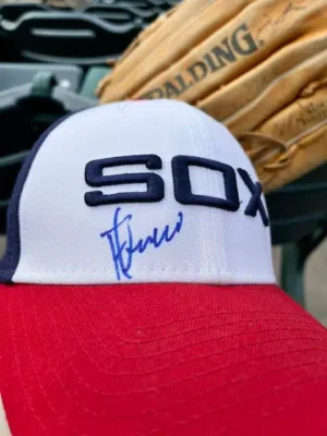 Sox Signature - TruFlex Media White Chicago White Sox cap with a blue autograph on the front, red brim, and a baseball glove blurred in the background.