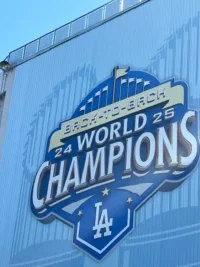 Twice as Nice - TruFlex Media Blue wall with a large sign reading'Back-to-Back World Champions 24' with the LA Dodgers logo at the bottom.