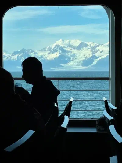 Dinner is Served - TruFlex Media Mountains in background as man dines on cruise ship in foreground