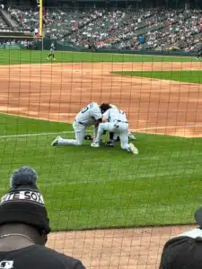Pre-Game Prayer - TruFlex Media three Chicago White Sox players gather in a prayer huddle before a Sunday game with Houston